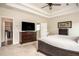 Spacious main bedroom featuring a ceiling fan, en-suite bathroom, and walk-in closet at 7345 Vale Ct, Cumming, GA 30028