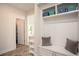Mudroom with built-in bench and storage, adjacent to pantry and living spaces at 7345 Vale Ct, Cumming, GA 30028