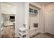 Mudroom with a built-in bench and storage, leading into the living room with a fireplace at 7345 Vale Ct, Cumming, GA 30028