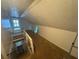 Unfinished attic space with stairs and window offers potential for extra storage or living area at 1785 S Olympian Sw Way, Atlanta, GA 30310
