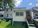 Backyard view featuring a house with a door, stairs, and a blue trash bin at 1785 S Olympian Sw Way, Atlanta, GA 30310