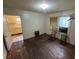 Bare bedroom with hardwood floors, blinds and a view into the kitchen at 1785 S Olympian Sw Way, Atlanta, GA 30310