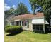 Charming single-story home with green shutters, an American flag, and a covered porch at 1785 S Olympian Sw Way, Atlanta, GA 30310