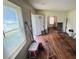 Empty living room with hardwood floors and lots of natural light from the window at 1785 S Olympian Sw Way, Atlanta, GA 30310
