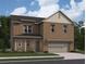 Charming brick two-story home featuring a two-car garage, manicured lawn, and traditional architectural details at 333 Torcello Blvd, Mcdonough, GA 30253