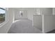 Bright neutral upper hallway with lots of light, gray carpet and white walls at 412 Corricella Ct, Mcdonough, GA 30253
