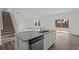 Open kitchen design with stainless steel appliances, granite countertop island, and hardwood floors at 412 Corricella Ct, Mcdonough, GA 30253