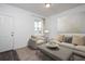 Cozy living room filled with natural light, neutral tones and stylish decor at 412 Corricella Ct, Mcdonough, GA 30253