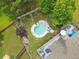 Aerial view of a private backyard, pool and deck surrounded by trees, providing a serene oasis at 648 York View Dr, Auburn, GA 30011
