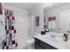 Bathroom with a shower-tub combo, black vanity, large mirror, gray walls and a modern sink at 648 York View Dr, Auburn, GA 30011