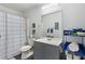 Well-lit bathroom with shower-tub combo, updated sink and vanity, gray walls and modern fixtures at 648 York View Dr, Auburn, GA 30011