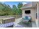 Cozy deck with outdoor seating, a mounted TV, and a wooded backyard view at 648 York View Dr, Auburn, GA 30011