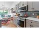 This modern kitchen has grey cabinets, stainless steel appliances and a gas range at 648 York View Dr, Auburn, GA 30011