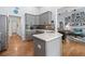 Well-lit kitchen features grey cabinets, stainless appliances, an island and an open floor plan at 648 York View Dr, Auburn, GA 30011
