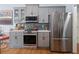 Modern kitchen features stainless steel appliances, gray cabinets, and white countertops at 648 York View Dr, Auburn, GA 30011