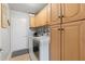 Functional laundry room features storage cabinets, a modern washer, and a dryer at 648 York View Dr, Auburn, GA 30011