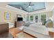 Spacious main bedroom with trey ceiling, hardwood floors, and access to outdoor deck at 648 York View Dr, Auburn, GA 30011