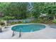 Backyard swimming pool with lounge chairs, landscaping, and privacy fence is great for relaxing and entertaining at 648 York View Dr, Auburn, GA 30011