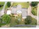 An overhead view of a home showing the roof, yard, patio, detached garage, and surrounding greenery at 2692 Wellington Dr, Marietta, GA 30062