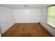 Vacant bedroom with hardwood floors, white walls, and a window providing natural light at 352 Price Rd, Carrollton, GA 30116