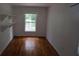 Modest bedroom featuring hardwood floors, white walls, and shelving and a window at 352 Price Rd, Carrollton, GA 30116
