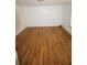 Empty bedroom with gleaming hardwood floors and white walls, featuring a bright window at 352 Price Rd, Carrollton, GA 30116