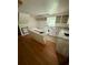 Bright kitchen featuring white cabinets, an island, and a double basin sink beneath a window at 352 Price Rd, Carrollton, GA 30116