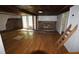 Spacious living room with hardwood floors, a stone fireplace, and double doors leading outside at 352 Price Rd, Carrollton, GA 30116