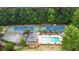 Aerial view of a pool and tennis courts, surrounded by lush greenery at 3616 Blakeford Ct, Marietta, GA 30062