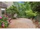 Serene backyard featuring a gravel patio, beautiful hydrangea, and mature trees at 3616 Blakeford Ct, Marietta, GA 30062