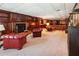 Basement lounge with dark wood built-ins, fireplace, wet bar, and plush seating at 3616 Blakeford Ct, Marietta, GA 30062