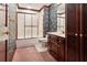 Bathroom with a shower-tub combo, floral wallpaper, and vanity at 3616 Blakeford Ct, Marietta, GA 30062