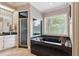 Elegant bathroom with a shower, a deep soaking tub, and striking black and white striped wallpaper at 3616 Blakeford Ct, Marietta, GA 30062
