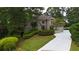 Beautiful home with lush landscaping and a long driveway leading to a spacious front yard at 3616 Blakeford Ct, Marietta, GA 30062