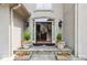 Inviting front entrance with stone steps, decorative planters, and a glimpse of the staircase inside at 3616 Blakeford Ct, Marietta, GA 30062