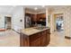 Spacious kitchen with a granite island, stainless steel refrigerator, wine rack, and dark cabinetry at 3616 Blakeford Ct, Marietta, GA 30062