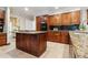 Spacious kitchen with wood cabinets, granite countertops, and island with cooktop, perfect for cooking at 3616 Blakeford Ct, Marietta, GA 30062