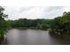 Scenic lake view surrounded by lush green trees, offering a serene and tranquil setting at 3616 Blakeford Ct, Marietta, GA 30062