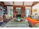 Warm living room features a wood-burning fireplace, ottoman and built-in bookshelves and cabinets at 3616 Blakeford Ct, Marietta, GA 30062