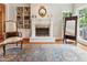 Inviting living room featuring a fireplace, built-in bookshelves, and a decorative gold mirror at 3616 Blakeford Ct, Marietta, GA 30062
