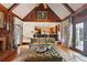 Inviting living room with wood paneling, fireplace and beamed ceiling, seamlessly flows into a modern kitchen at 3616 Blakeford Ct, Marietta, GA 30062