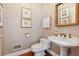 Elegant powder room featuring a pedestal sink, decorative wallpaper, and stylish fixtures at 3616 Blakeford Ct, Marietta, GA 30062