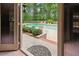 View of the pool from inside the house, overlooking the patio furniture and landscaping at 3616 Blakeford Ct, Marietta, GA 30062