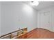 Basement room with unfinished repairs, showcasing wooden floors and a white door at 370 Beracah Sw Trl, Atlanta, GA 30331