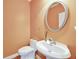 Half bath with a modern sink and toilet, and peach walls at 370 Beracah Sw Trl, Atlanta, GA 30331