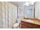 Bathroom with a sink, vanity with granite countertop, toilet, and shower with yellow curtain at 370 Beracah Sw Trl, Atlanta, GA 30331