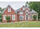 Elegant brick home with manicured lawn, arched windows, and distinctive architectural details at 370 Beracah Sw Trl, Atlanta, GA 30331
