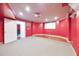 A red home theater with a projector screen and elevated seating area at 370 Beracah Sw Trl, Atlanta, GA 30331