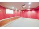 A red home theater with a projector screen and elevated seating area at 370 Beracah Sw Trl, Atlanta, GA 30331