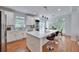 Bright kitchen with white cabinets, stainless steel appliances, a large island and hardwood flooring at 370 Beracah Sw Trl, Atlanta, GA 30331